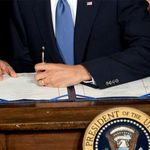 President Obama signs the health insurance reform bill